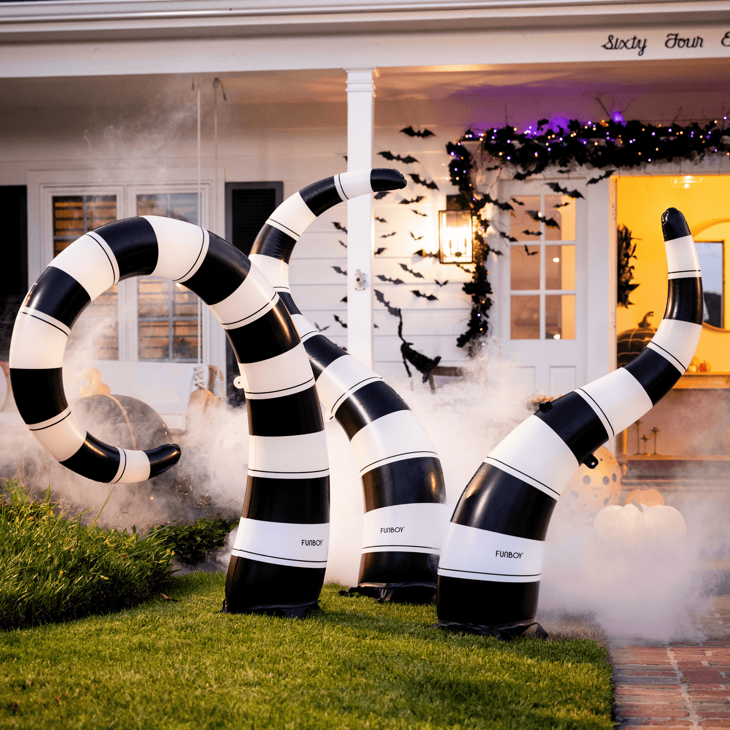 Creep it Real  Transform your lawn into a slithering spectacle with FUNBOY’s Light-Up Inflatable Yard Snakes. These black and white snakes emerge from the ground, casting a glow that changes colors with the click of a remote. Securely staked, these Yard Snakes stay put and are built with durable material to last through the fall climate. Configure them in any way that enhances your spooky setup.   Spook in style